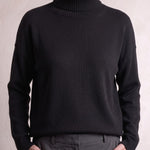 Women's Relaxed Fit Roll Neck Jumper in Black, close-up of the upper body.