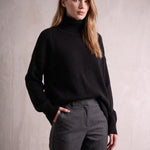 Women's Relaxed Fit Roll Neck Jumper in Black, front view, full length.