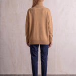 Women's Relaxed Fit Roll Neck Jumper in Camel, back view, full length.