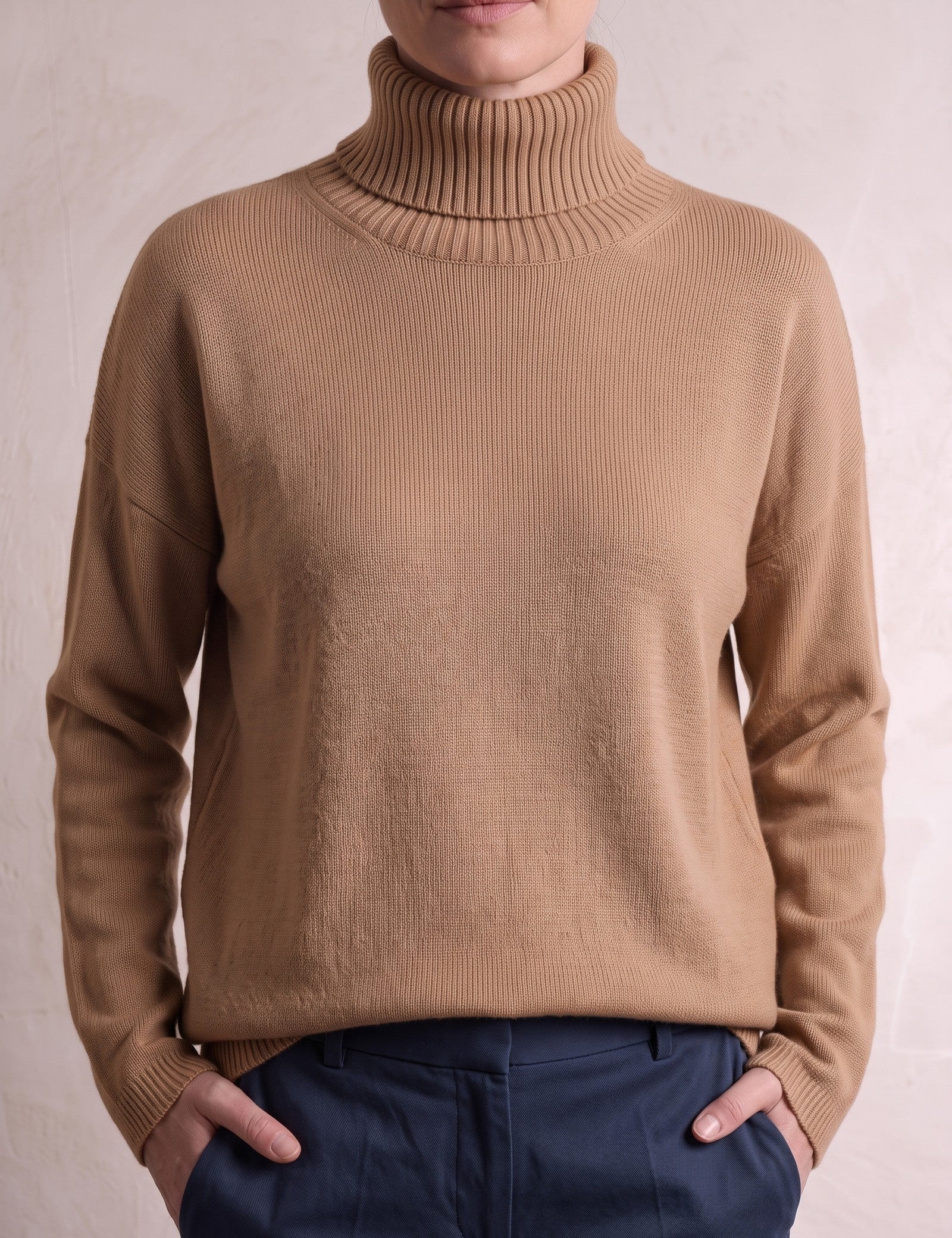 Women's Relaxed Fit Roll Neck Jumper in Camel, close-up of the upper body.