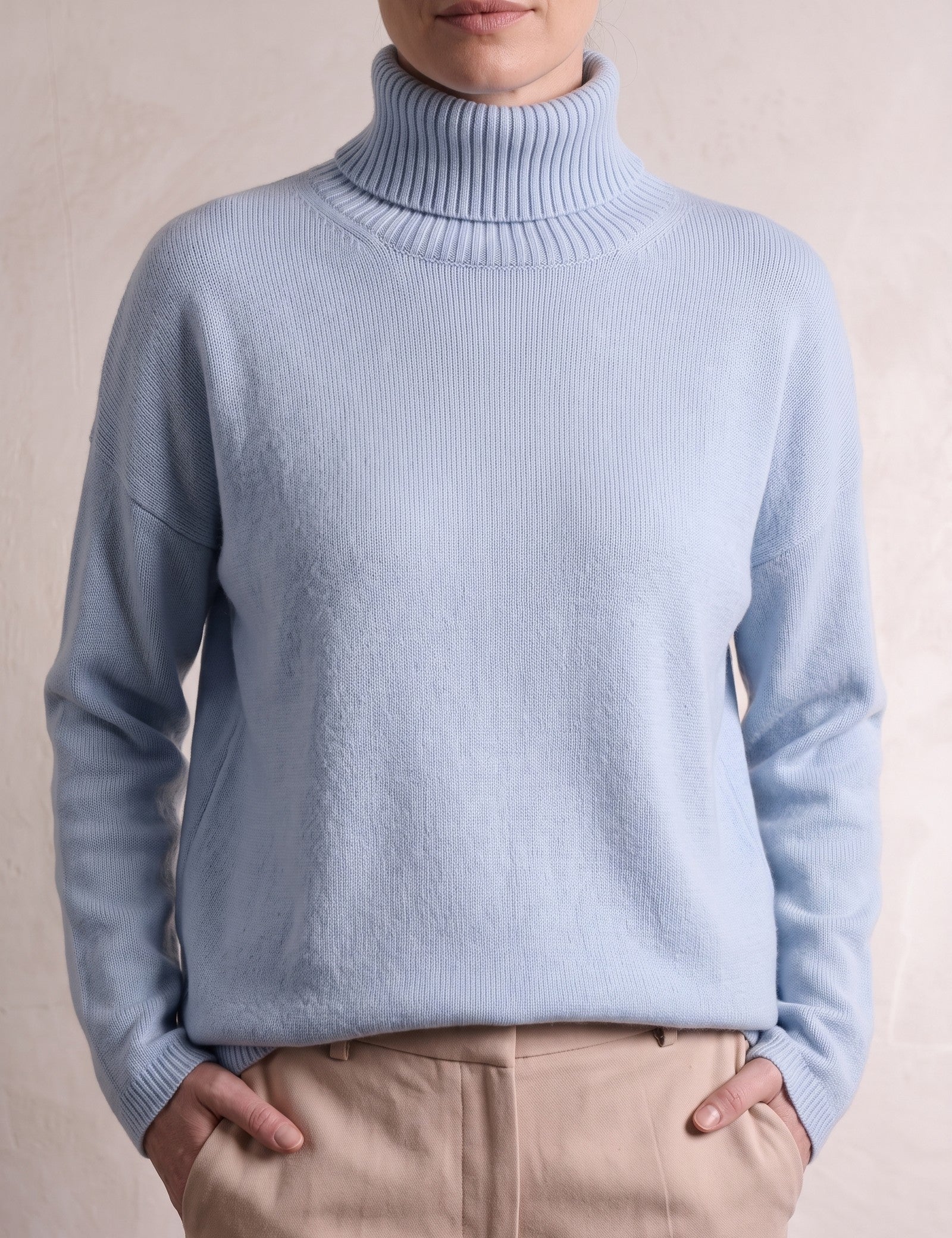 Women's Relaxed Fit Roll Neck Jumper in Light Blue, close-up of the upper body.