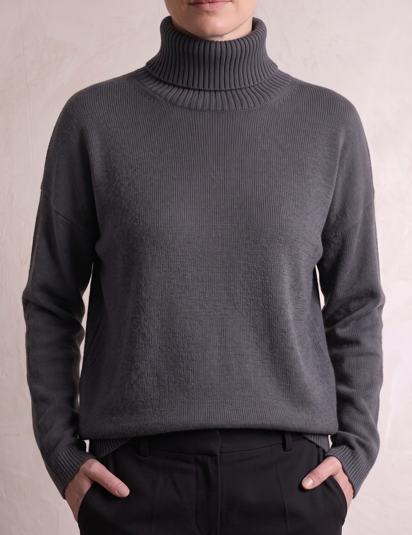 Women's Relaxed Fit Roll Neck Jumper in Dark Grey, close-up of the upper body.